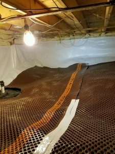 Drainage matting being installed under Vapor Barrier for moisture/water control