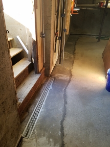 Open trench drain at doorway landing