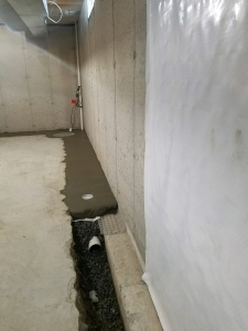 Concrete installed back over the drainage system.