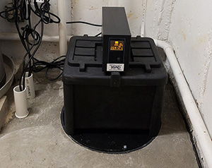 Black waterproofing drainage system in basement by Premier Basement Waterproofing in Lunenburg, MA